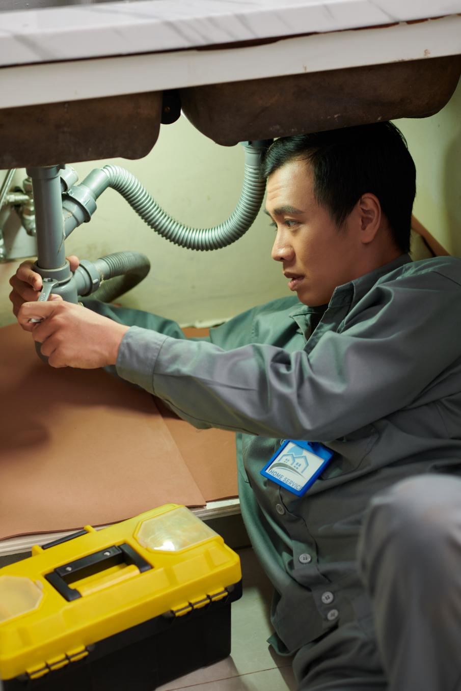 Skilled plumber using specialized tools for pipe fitting and maintenance